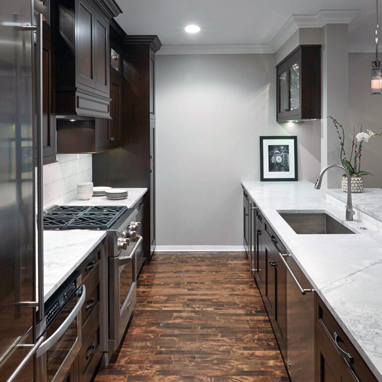 galley kitchen with aged hardwood floors
